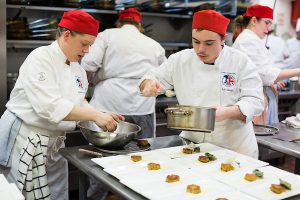Loyalist Culinary 2016 Students plating dishes for dinner service.